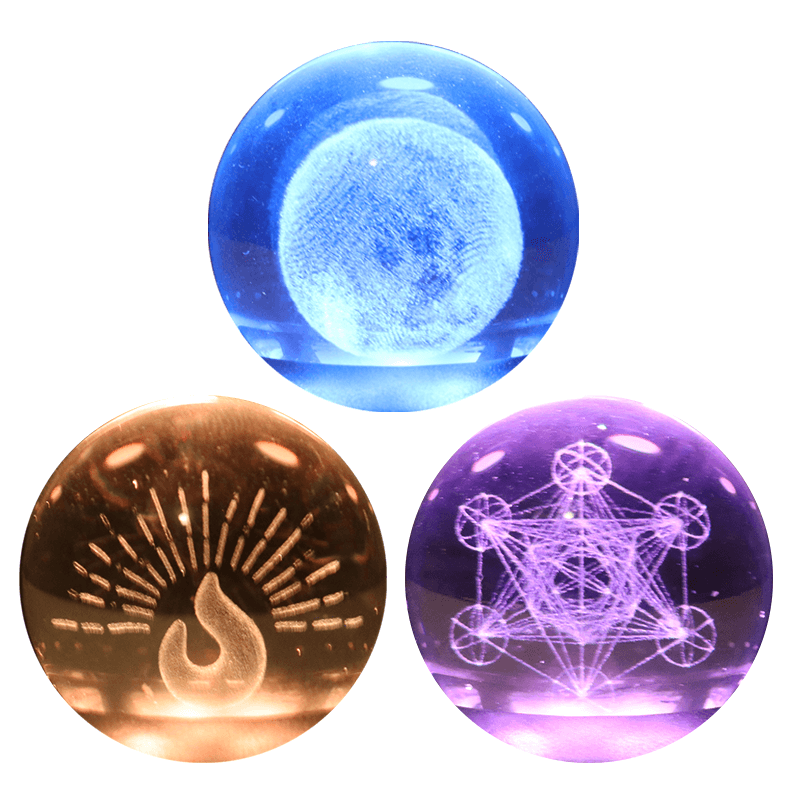 Three illuminated crystal balls: fire, moon, and sacred geometry designs for Oracle Essential Oil Diffuser.