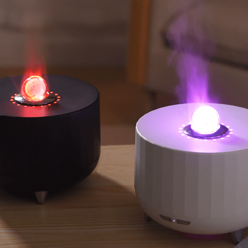 Oracle Crystal Ball Flame Essential Oil Diffuser in black and white, emitting colorful mist and light.