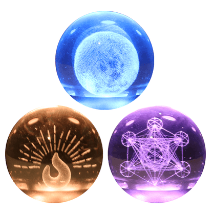 Three illuminated crystal balls: fire, moon, and sacred geometry designs for Oracle Essential Oil Diffuser.